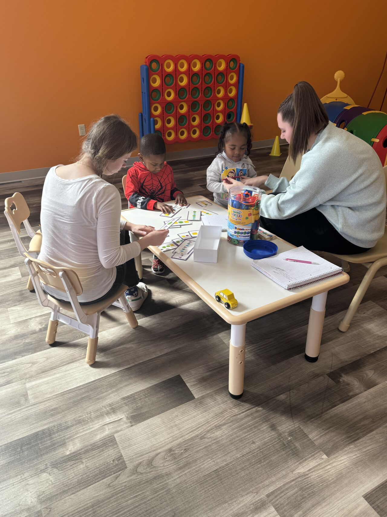 Student playing cards with kids