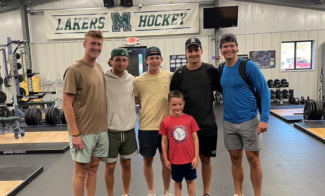 Jace Keeley (center) with Mercyhurst Men's Hockey team members