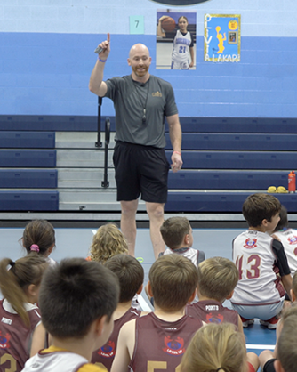 Adam Grady speaking to kids in gym