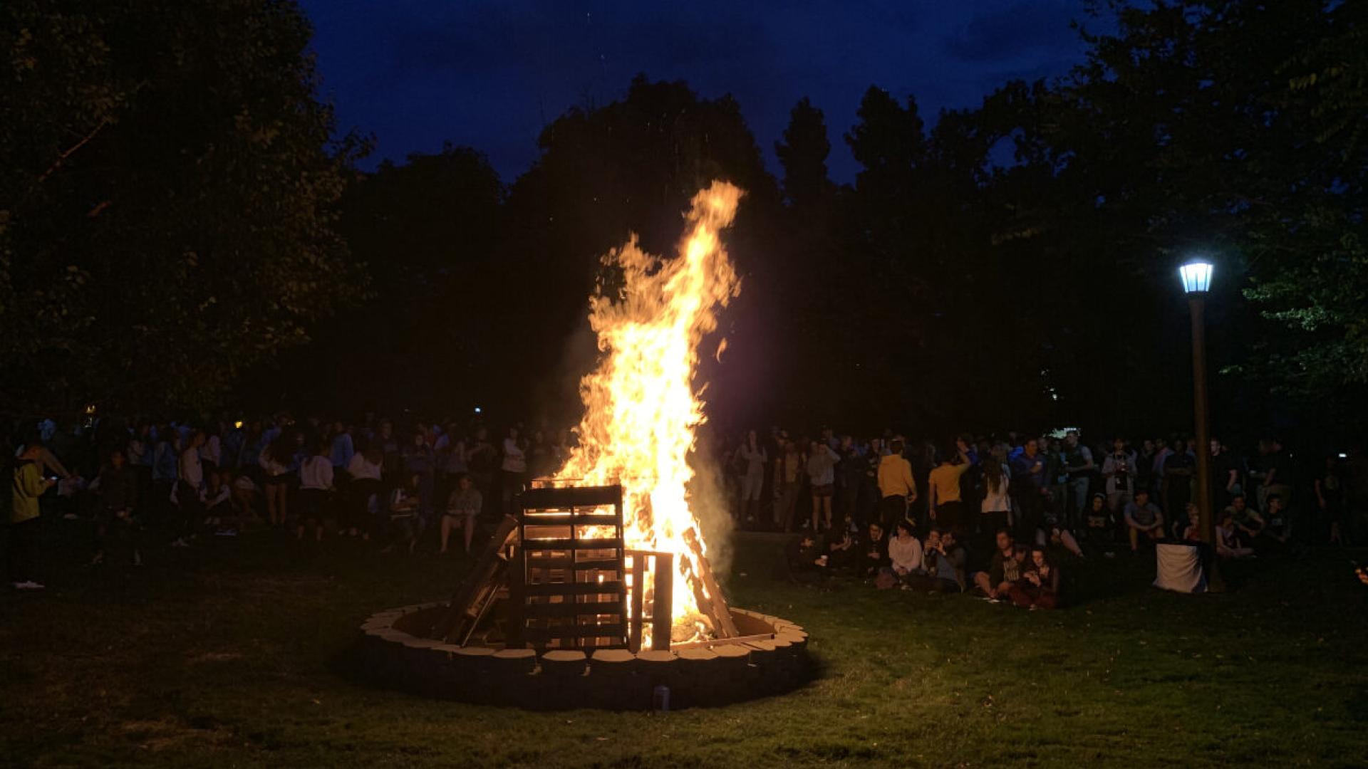 Students gathering around the homecoming bonfire