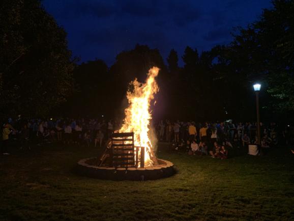 Students gathering around the homecoming bonfire