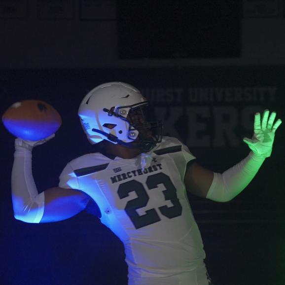 Mercyhurst Football Player throwing a football in the Athletic Center