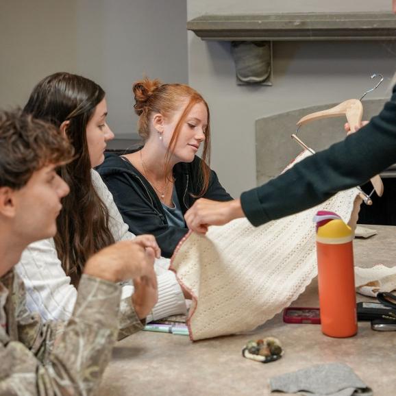Fashion Merchandising students looking at textiles