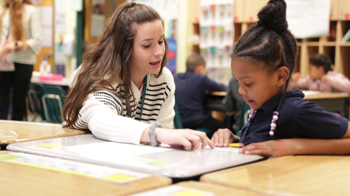 Education Student teaching a child at the 2019 Carpe Diem Academy