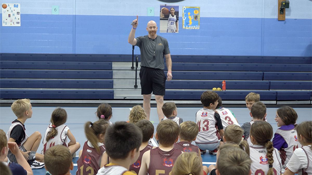 Adam Grady speaking to kids in gym
