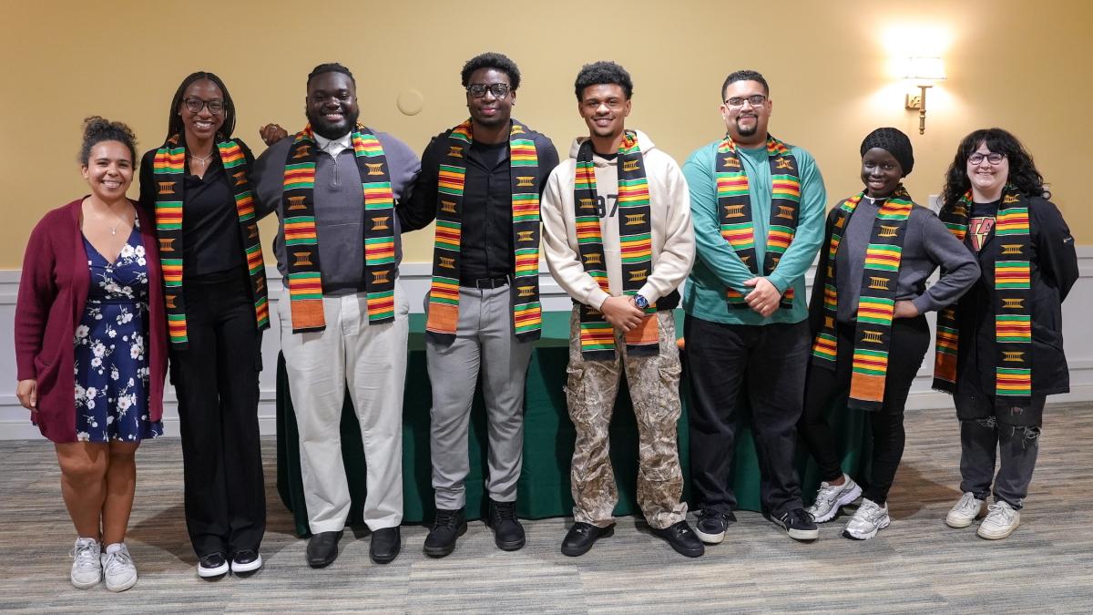 A group of Mercyhurst students wear traditional Kente Stoles