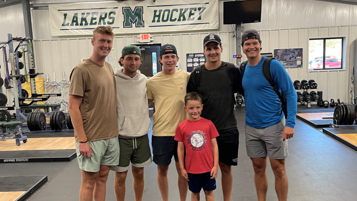 Jace Keeley (center) with Mercyhurst Men's Hockey team members
