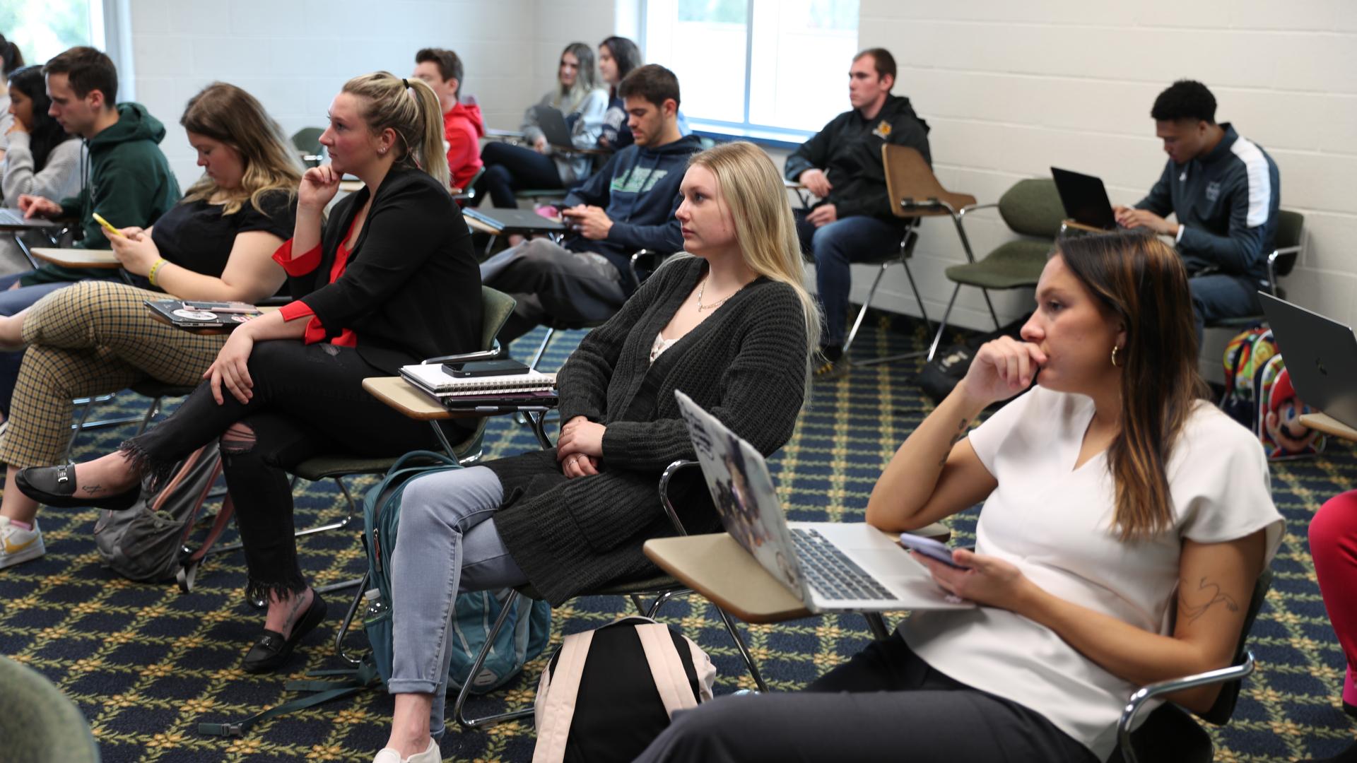 a classroom of students sitting in desks