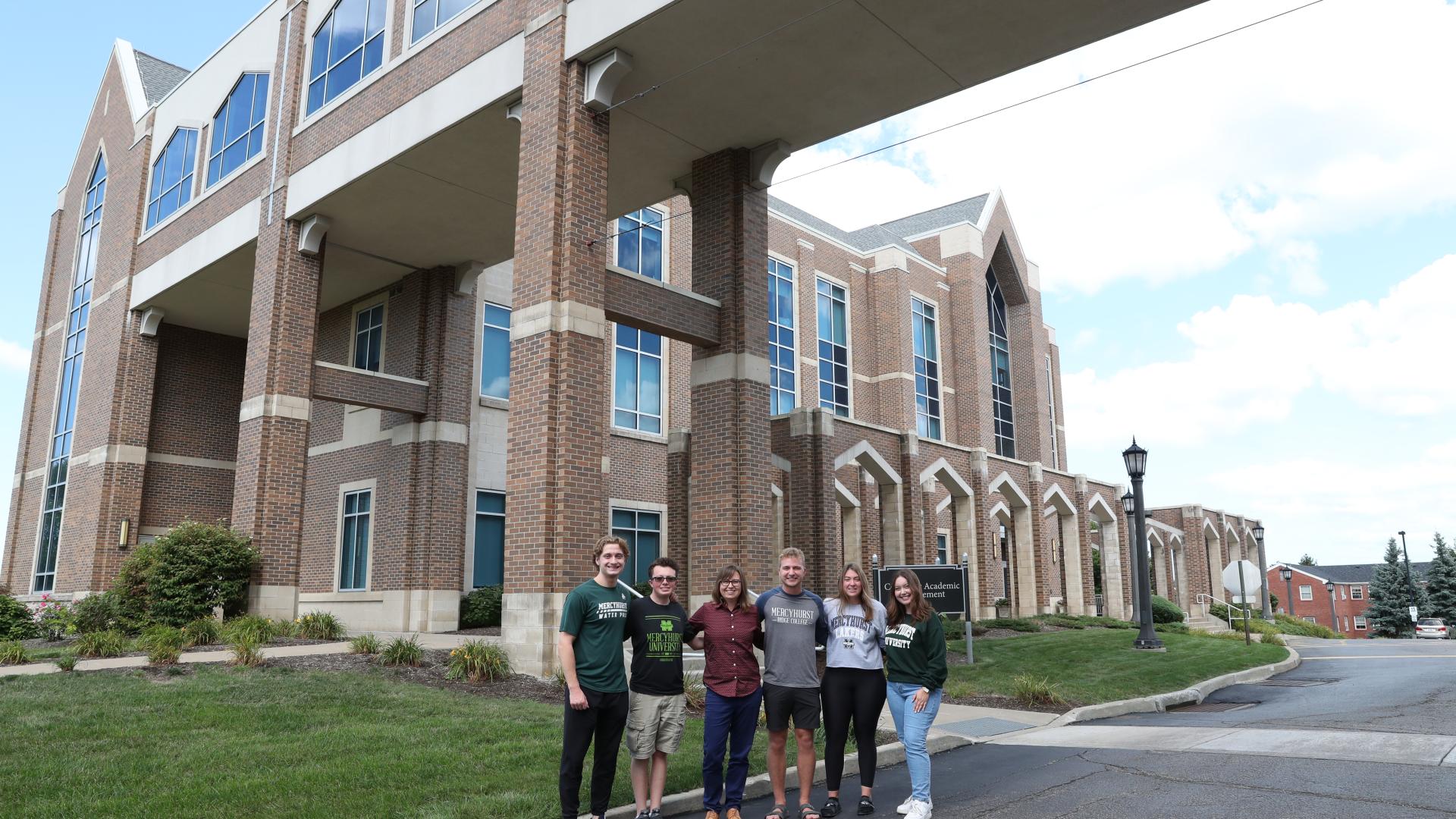 Students and professor in front of Center for Academic Engagement