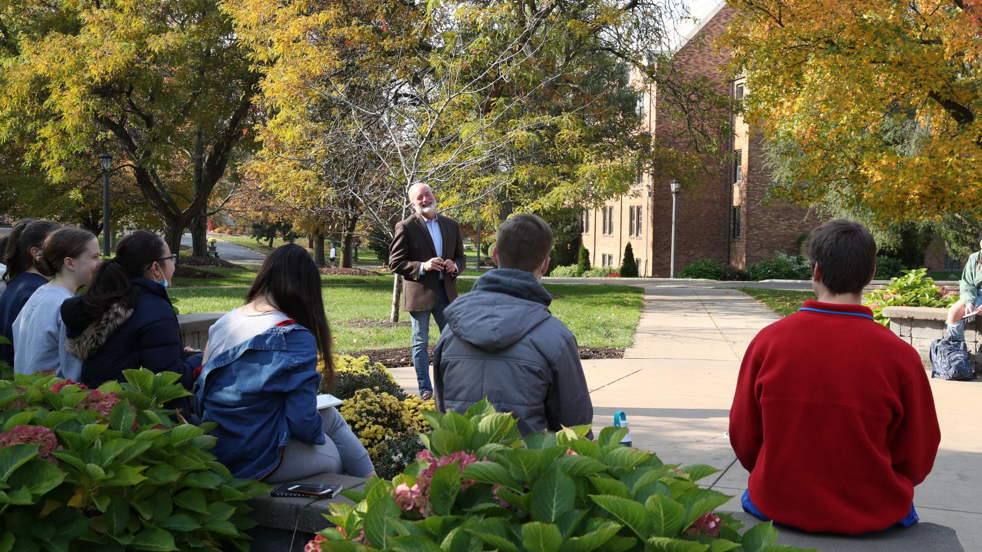 a professor teaches a class outside 