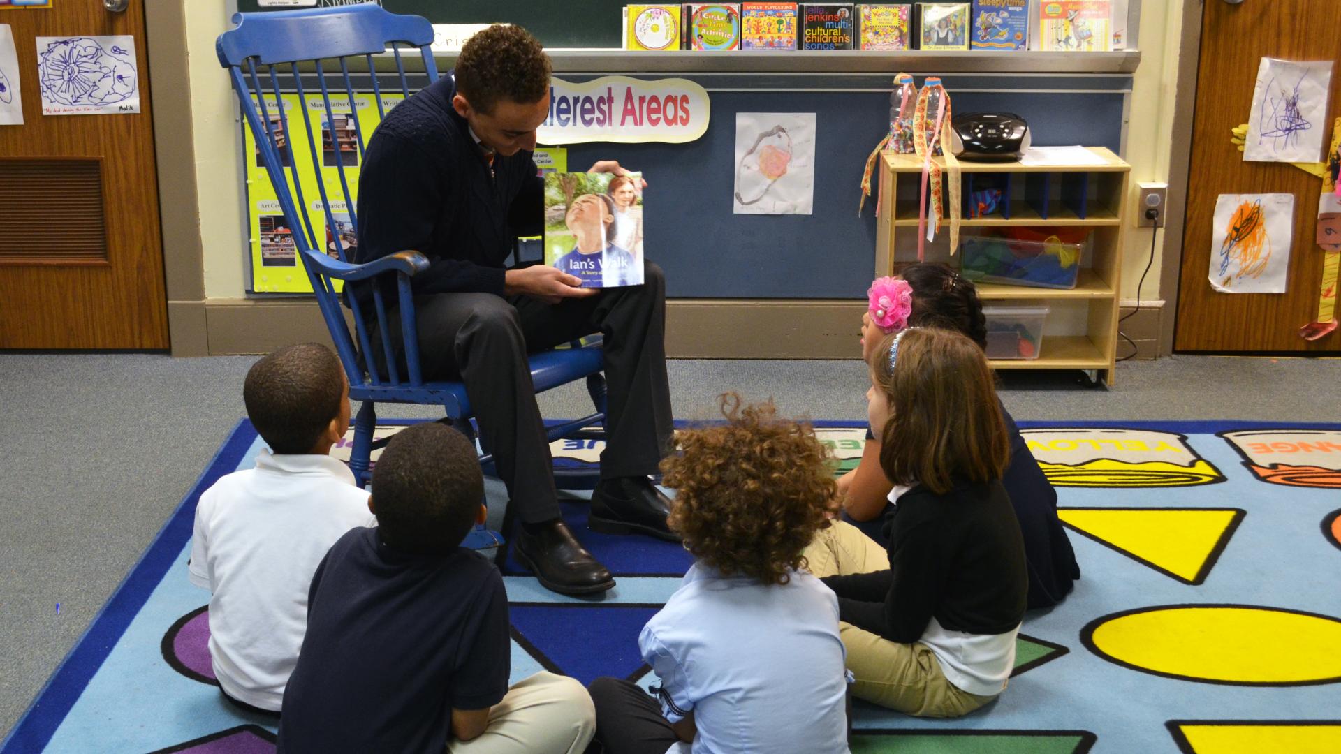 Teacher reading to children in classroom