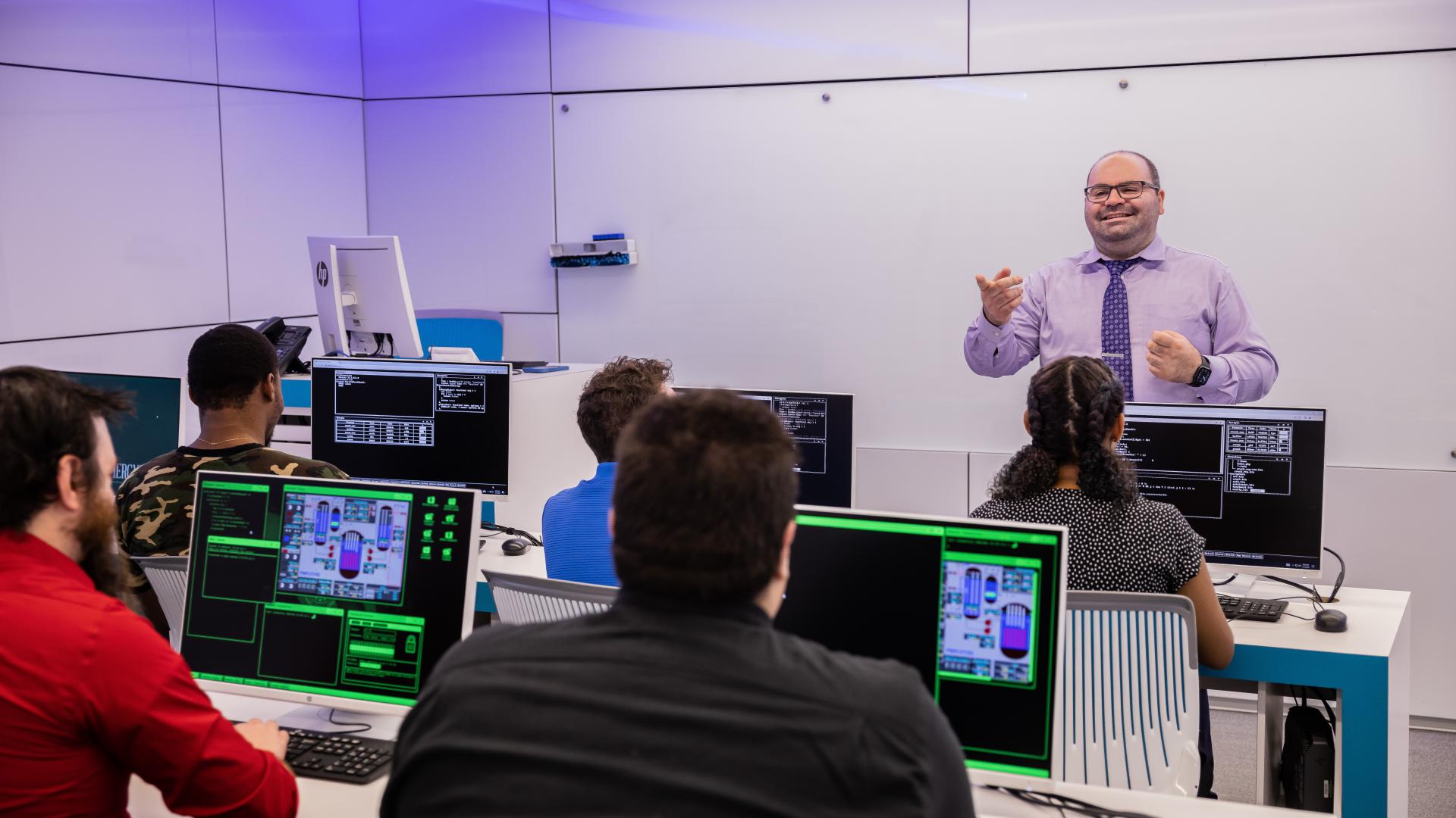a professor teaching a group of cyber security students