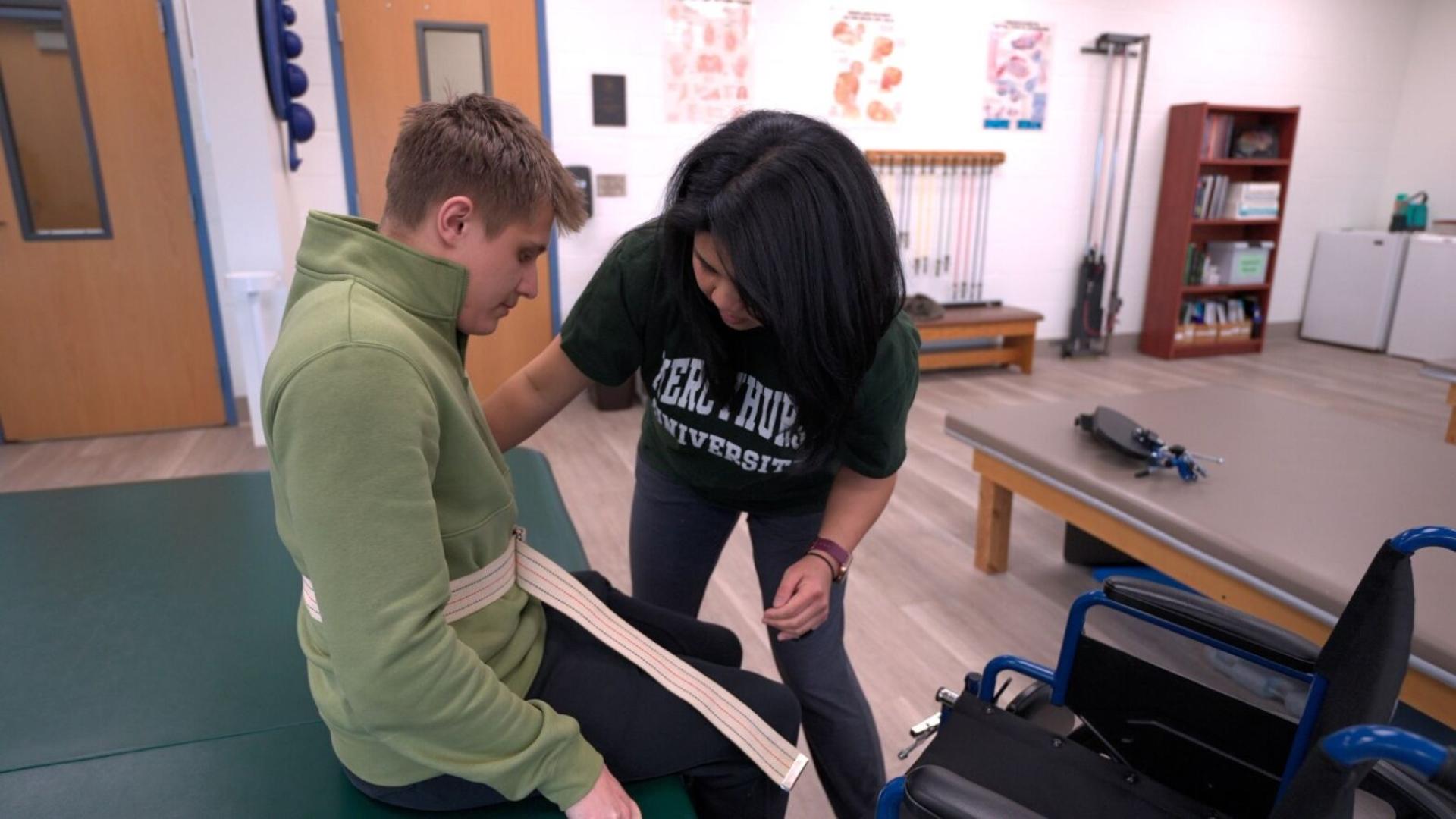 Student treating a patient through physical therapy