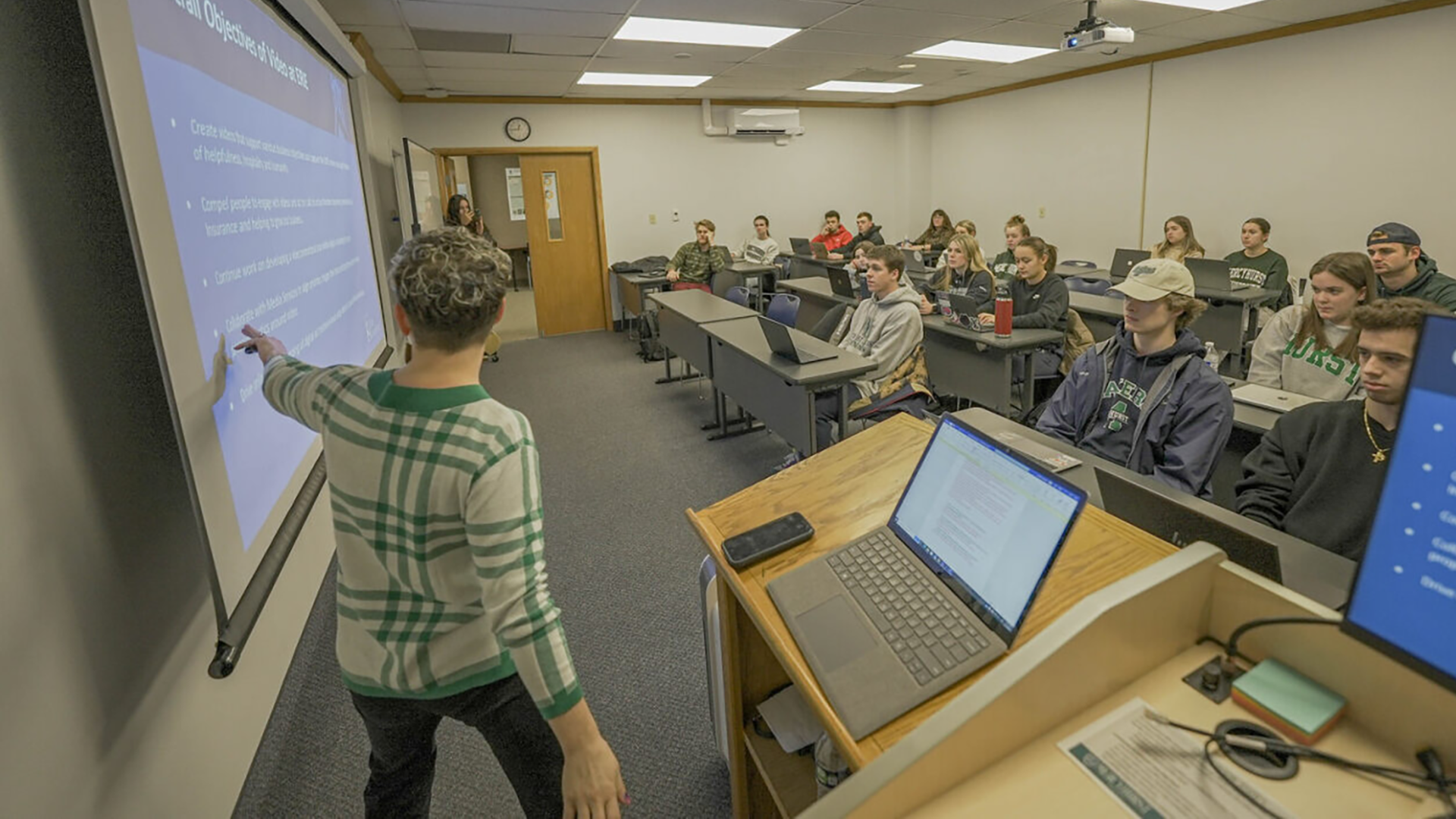 Guest speaker giving a presentation to marketing students in a classroom setting