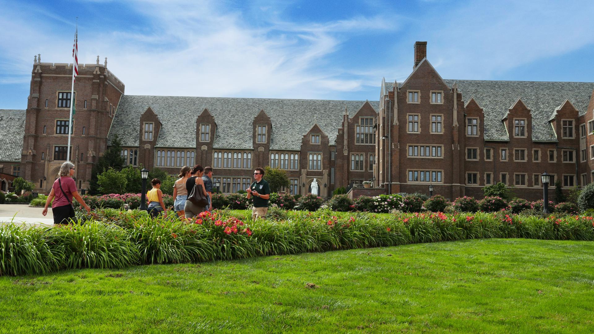 Campus tour group walking in front of Old Main