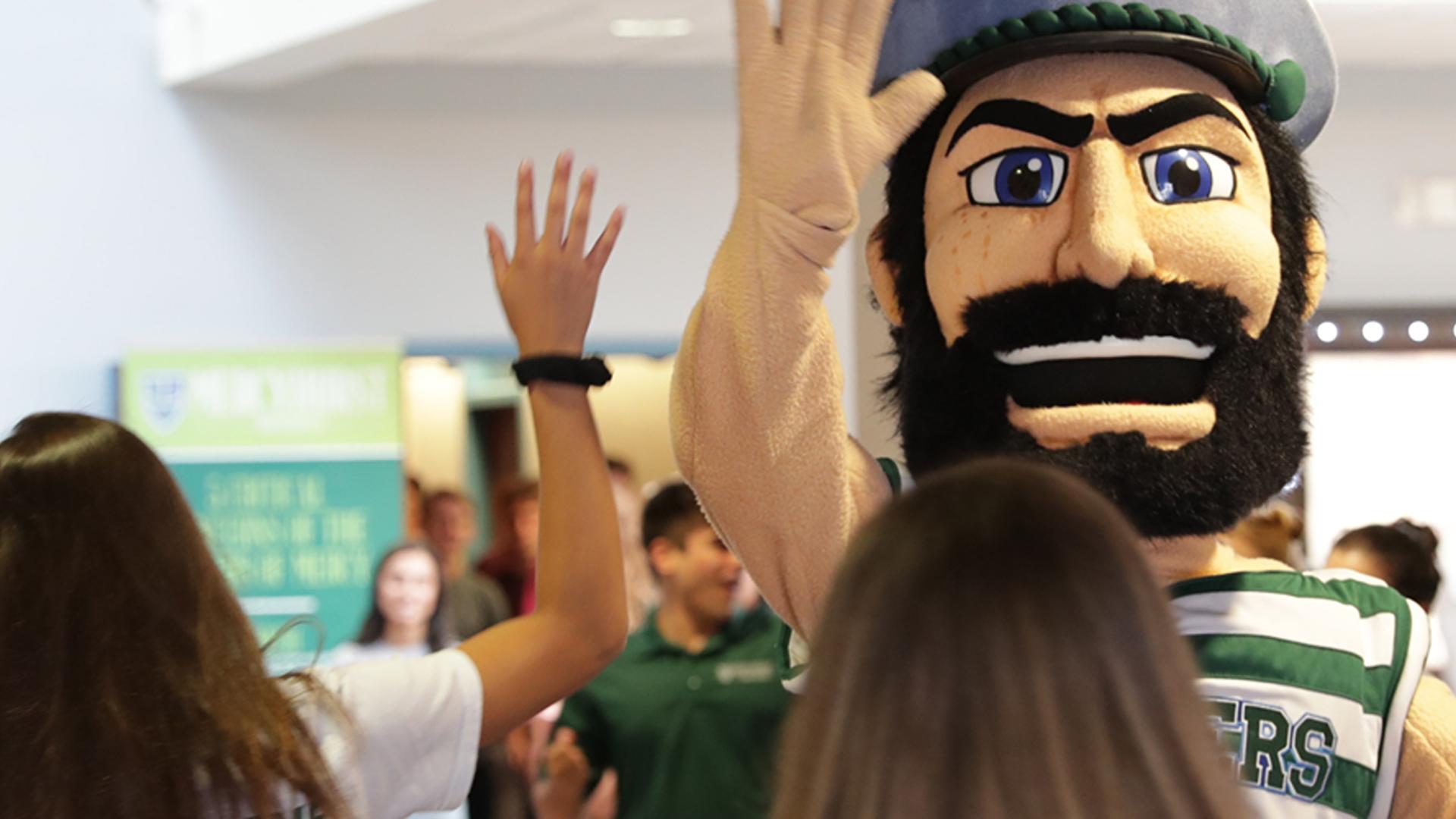 Mascot giving student high five