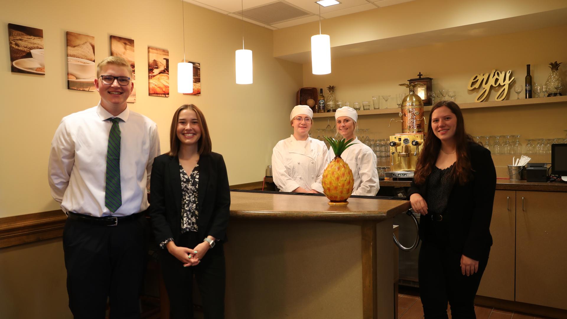 Hospitality students in front of cafe counter