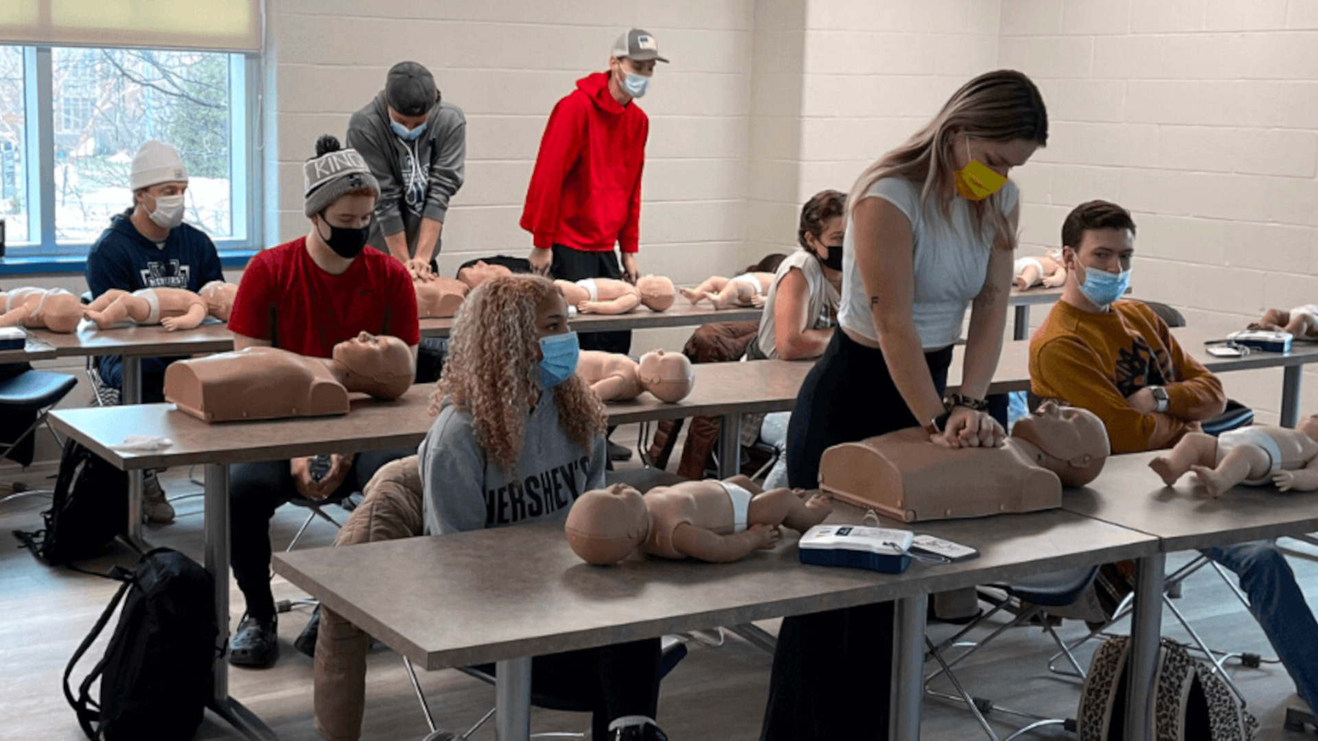 Students using dummies to practice life support training