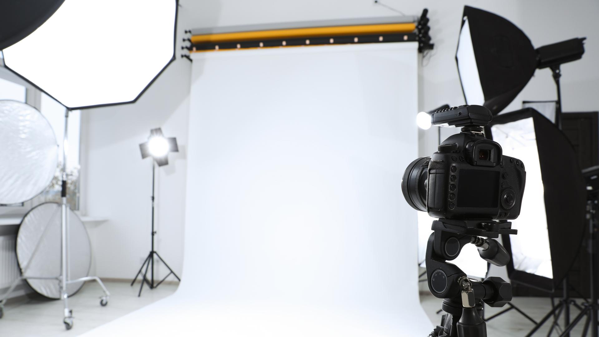 Photography studio with lights, camera, and backdrop