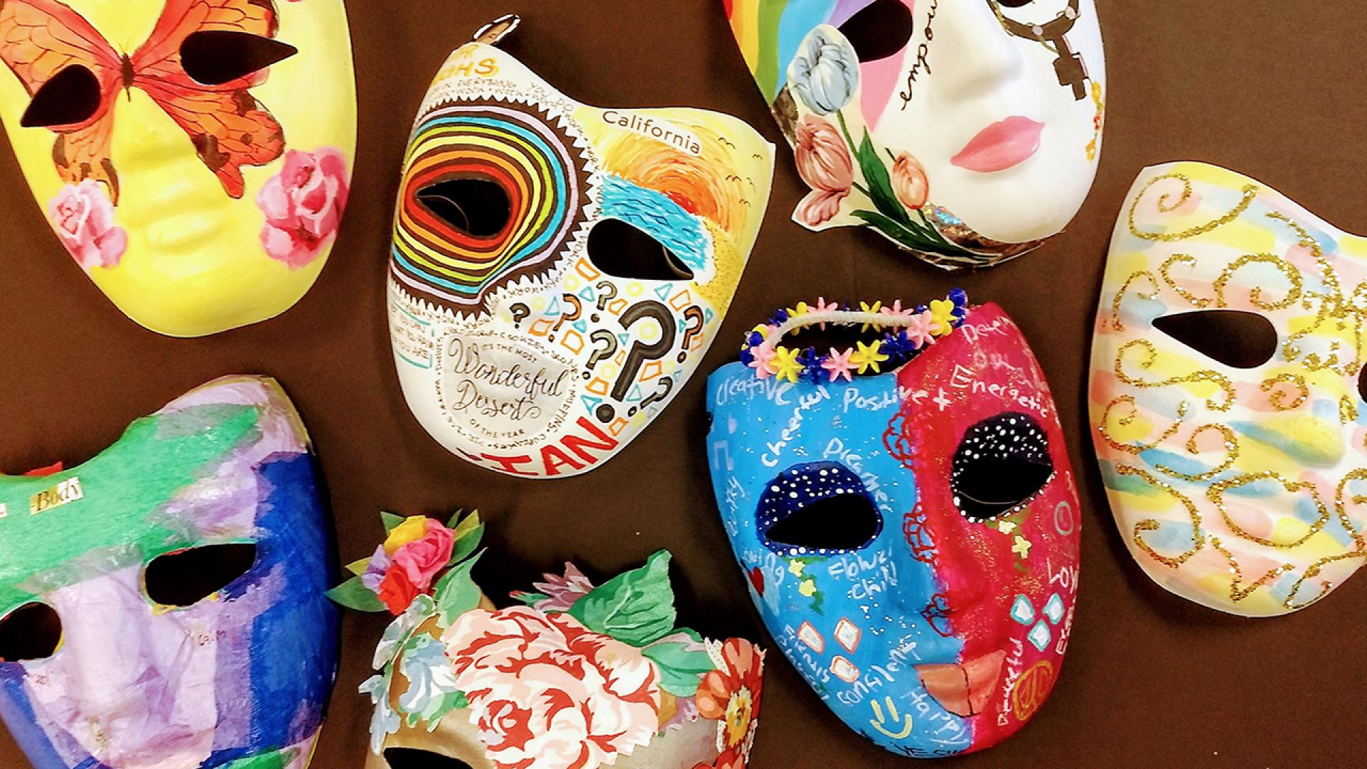 Colorful theatre face masks, laying on a table