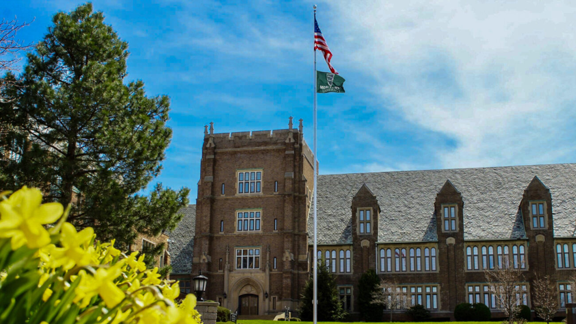 Old Main outside with yellow daffodils