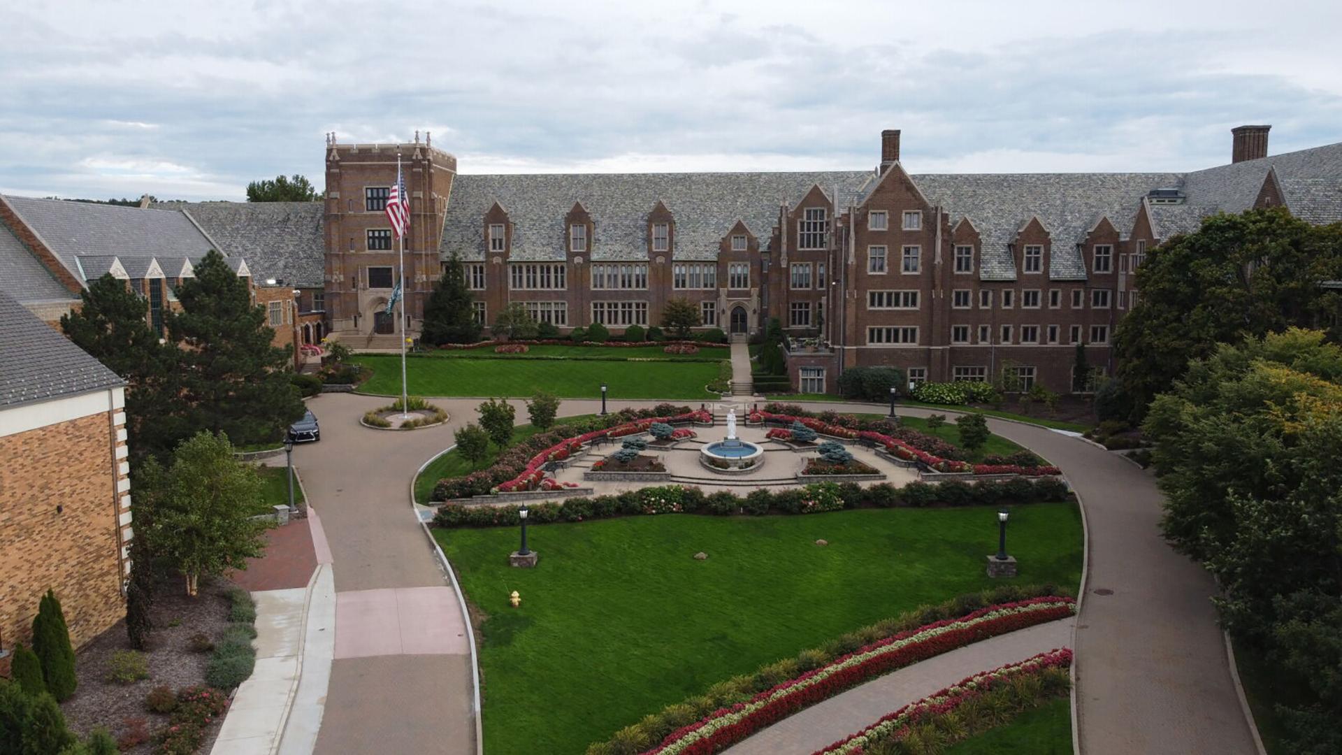 Old Main and Mary Garden with American and Mercyhurst flag