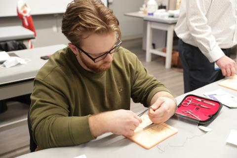 Student practicing stitches.