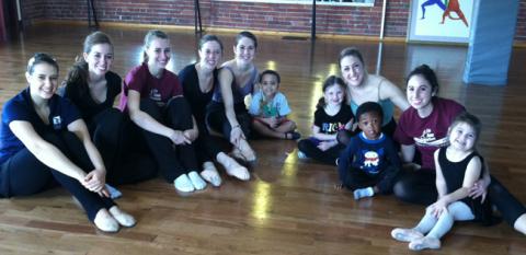 Students working with young dancers
