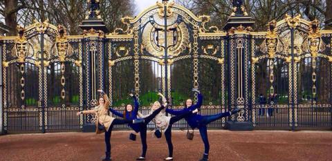 Students posing outside an ornate gate in an international location