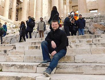 Student sits on steps outside while study abroad