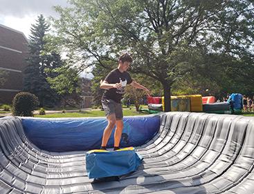 Student setting up outdoor festival