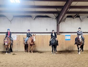 Students riding horses