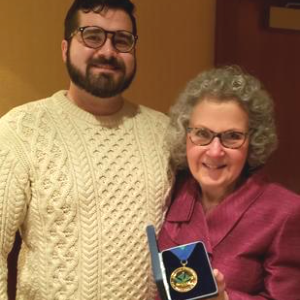 Jane Kelsey and son after receiving her award