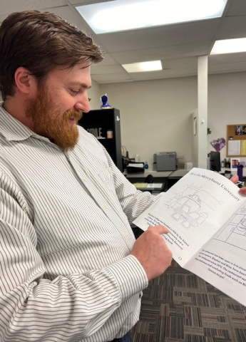 Dr. Benjamin Scharff flipping through coloring book