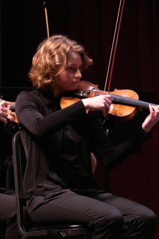 Student Violinist playing a violin