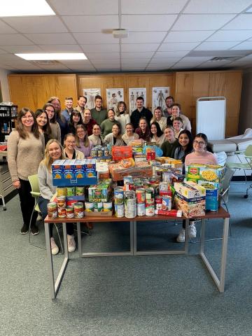Group photo of students and collected food to combat food insecurities