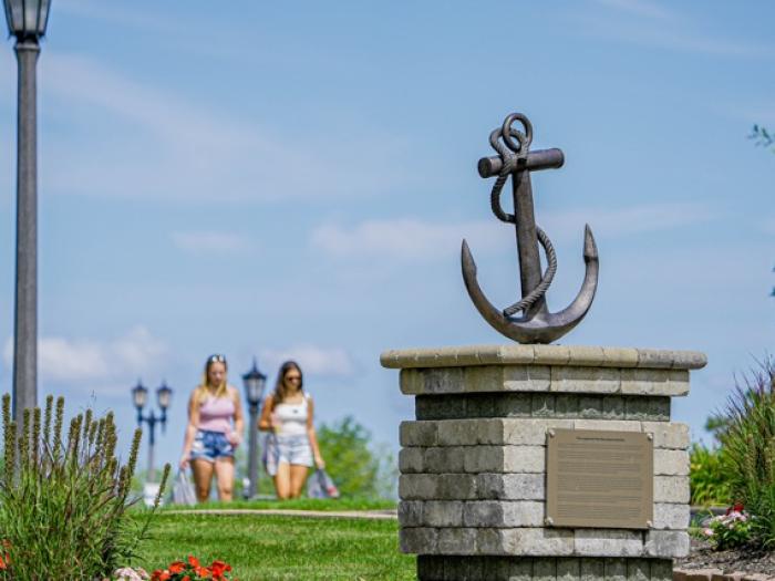 Anchor statue with students walking