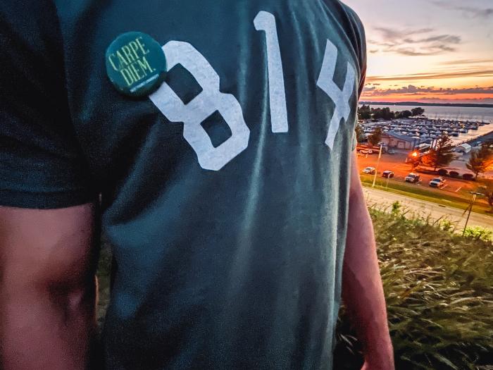 person wearing an 814 shirt in front of erie skyline