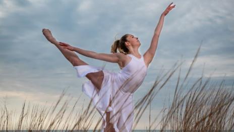 Water Dance performer posing in a field of grass