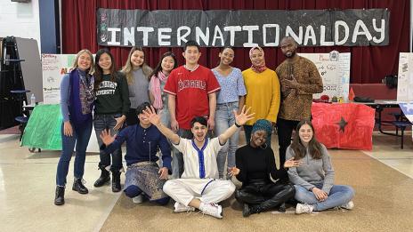 Mohcine “Mo” Khadraoui and 12 other Mercyhurst students posing for a photo on International Day