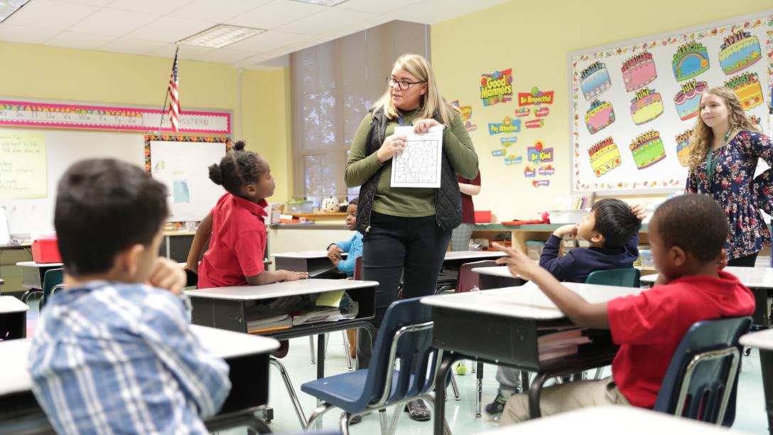 a female student teacher instructs students