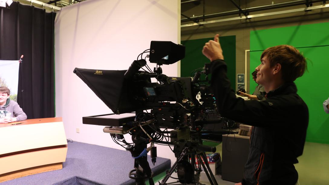 a male student operates a camera