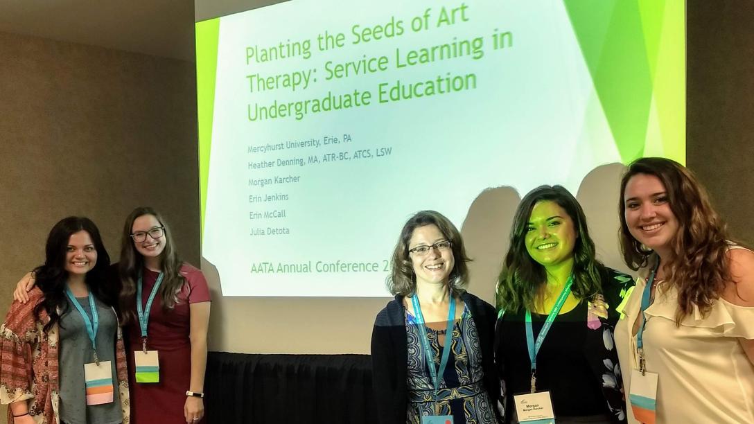 students and faulty pose at a conference