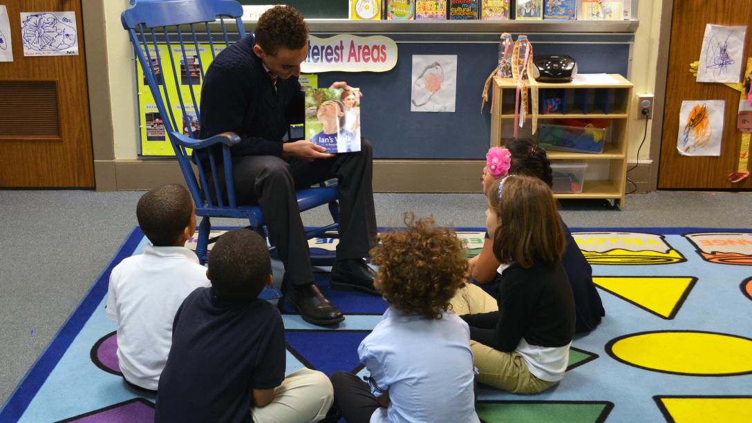 Education student-teacher reading to students