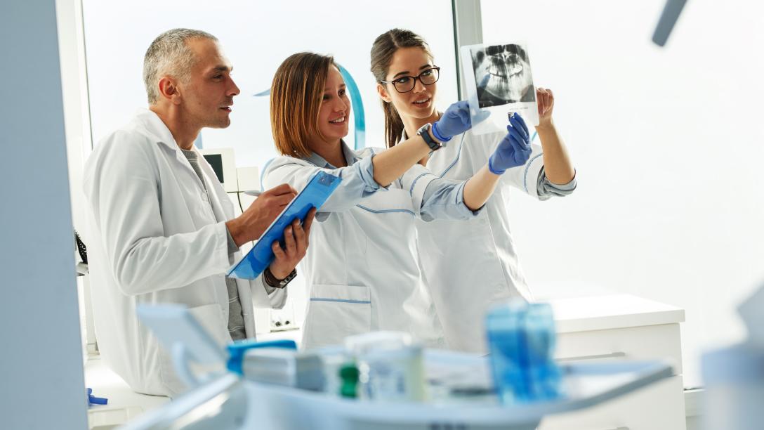 Instructor and students examine xray