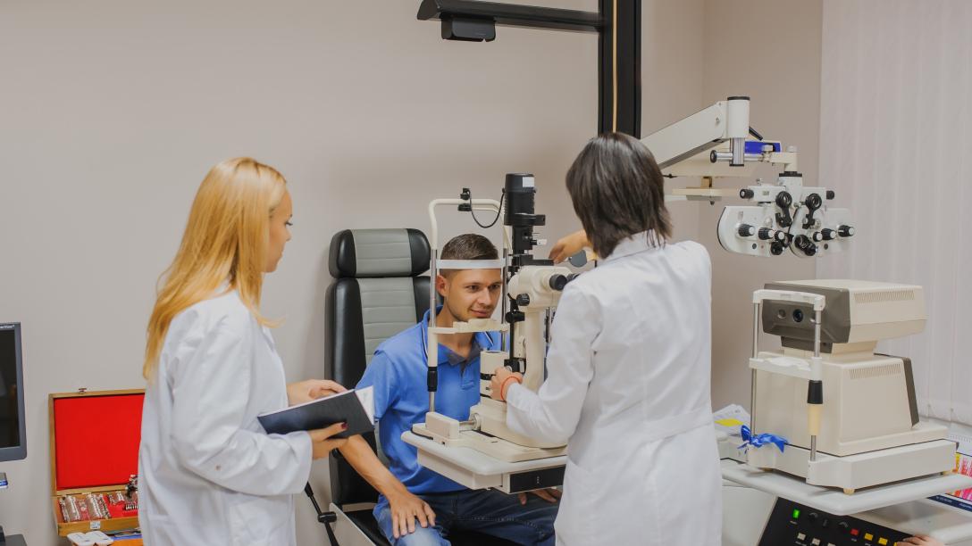 two medical students complete eye exam