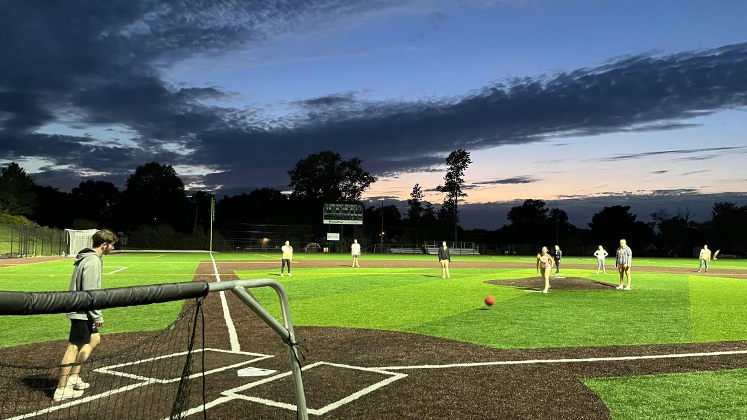 students play kickball at dusk at mercyhurst