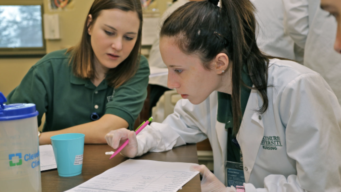 Students looking at lab equipment.