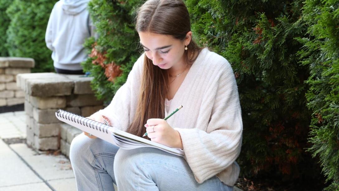 Art student sketching outdoors