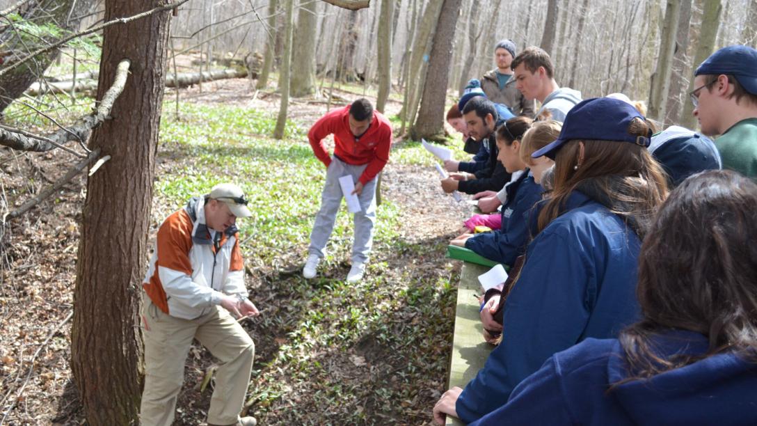 Environmental Science students observing tree sample on class trip